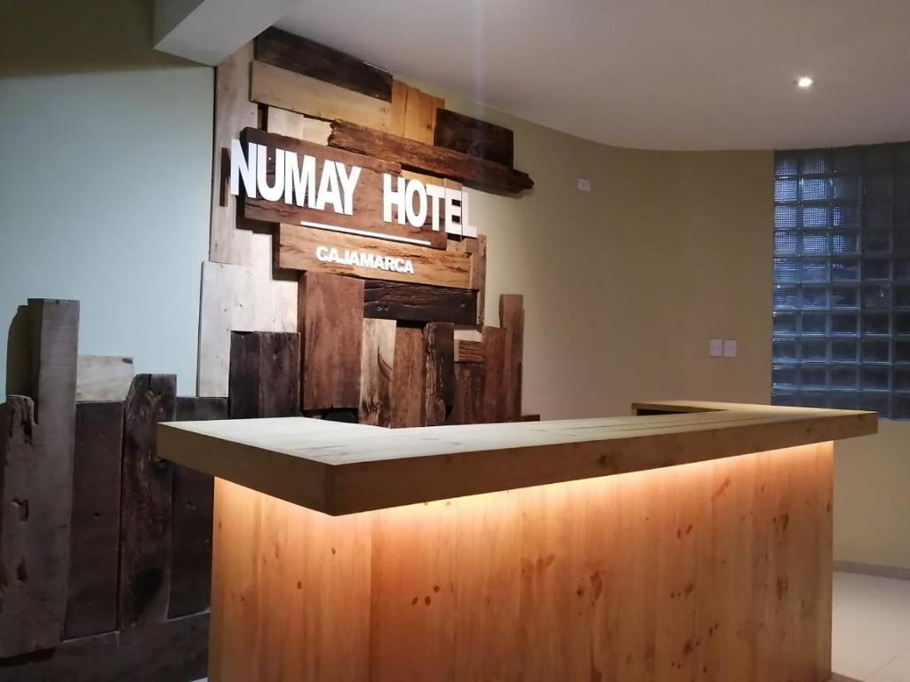 a kitchen with a counter with a sign on the wall at Hotel NUMAY in Cajamarca