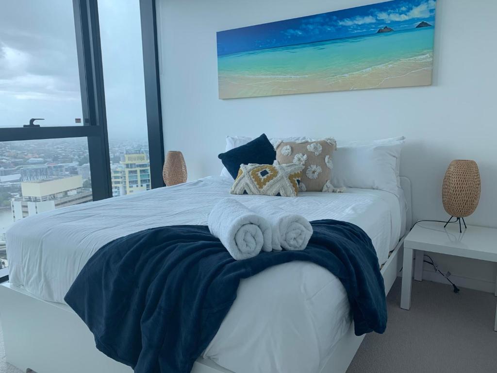 a bedroom with a bed with towels on it at Lvl 50 Skytower Fabulous Views CBD Wifi Carpark by Stylish Stays in Brisbane