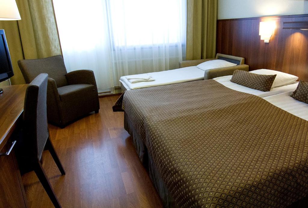 Ένα ή περισσότερα κρεβάτια σε δωμάτιο στο Spa Hotel Rauhalahti