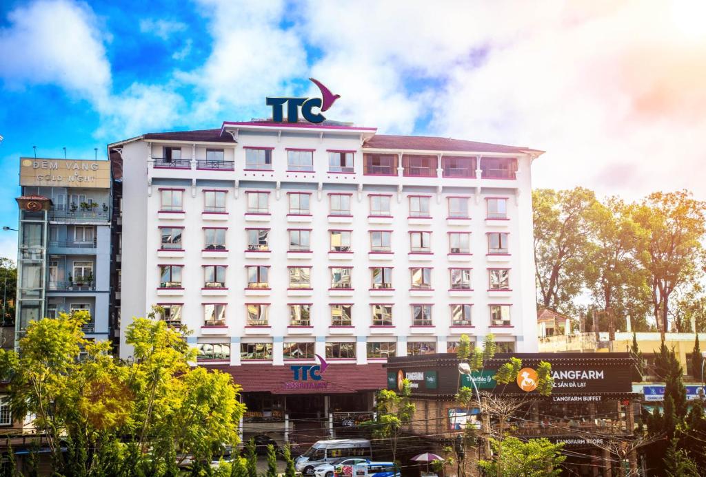 a white building with a sign on top of it at TTC Hotel - Da Lat in Da Lat