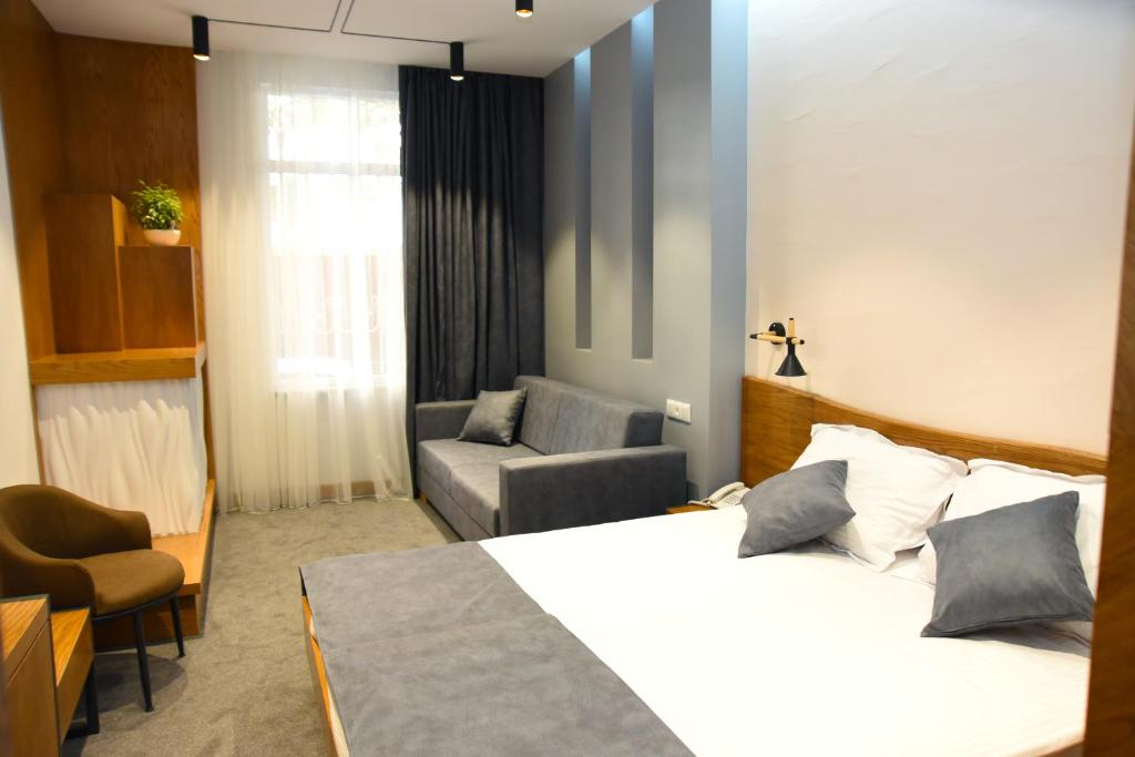 Postel nebo postele na pokoji v ubytování R&R Hotel