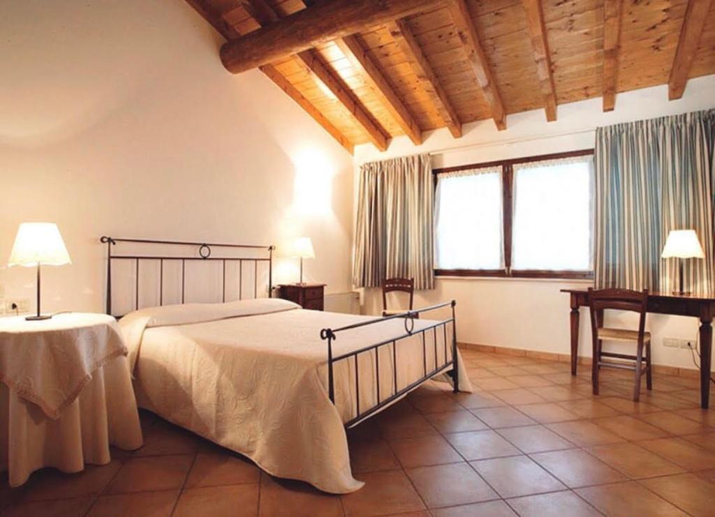 Postel nebo postele na pokoji v ubytování Agriturismo Bitturelli