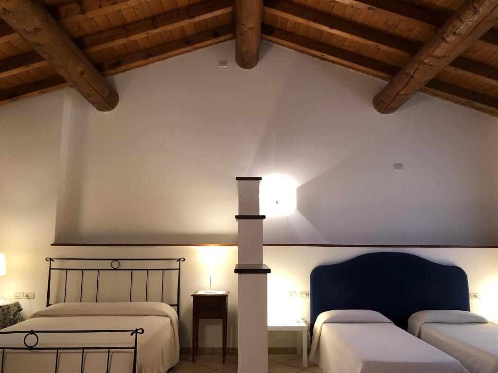 Postel nebo postele na pokoji v ubytování Agriturismo Bitturelli