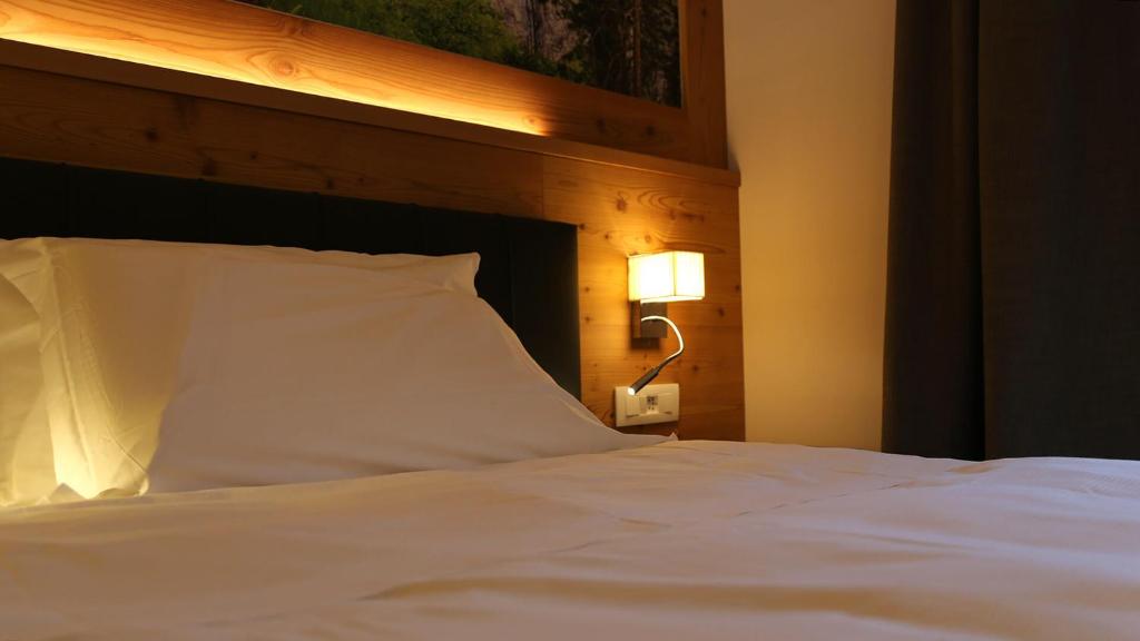 Postel nebo postele na pokoji v ubytování Dada Mountain Hotel