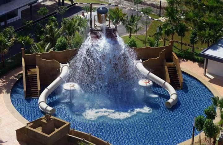 a water slide in a pool at a resort at Studio Homestay SGarden Resort Residences in Kuantan