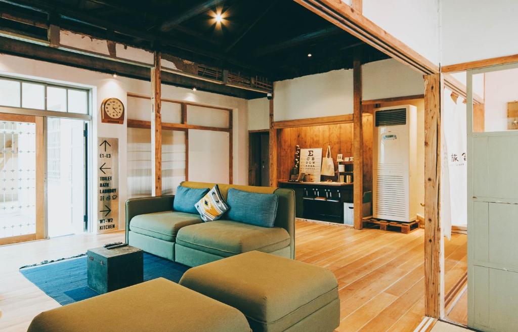 a living room with a couch and a table at Goonnight Hostel in Kaohsiung