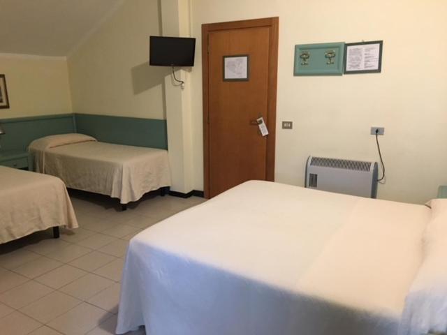 Postel nebo postele na pokoji v ubytování Hotel Marina
