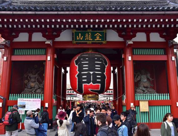 a crowd of people standing outside of a building with a sign at Tokyo inn Sakura An in Tokyo