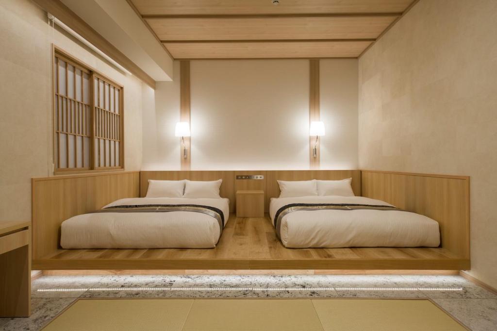 Postel nebo postele na pokoji v ubytování IAM HOTEL