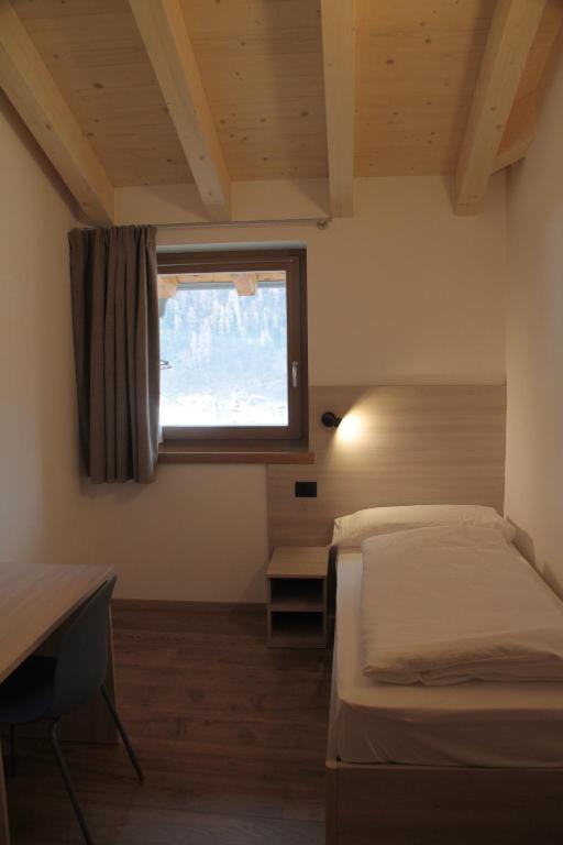 Posteľ alebo postele v izbe v ubytovaní MOUNTAIN RESORT Appartamenti