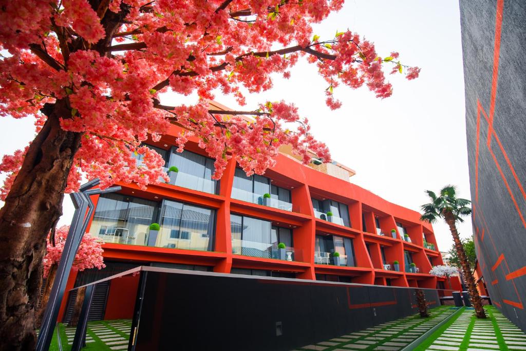 an orange building with a tree in front of it at Bel Air Crest in Accra