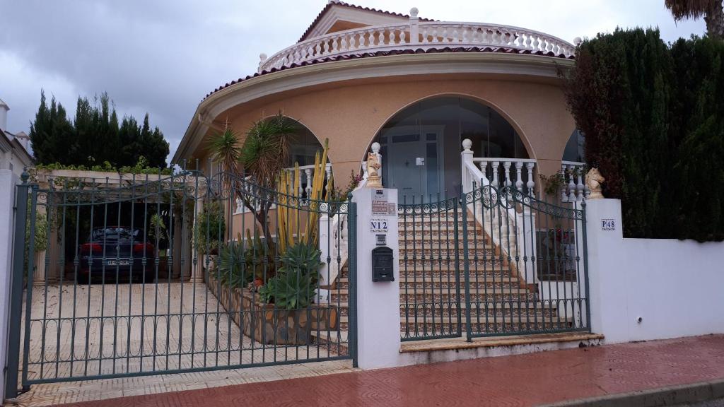 a white gate in front of a house at casa ronda in Rojales