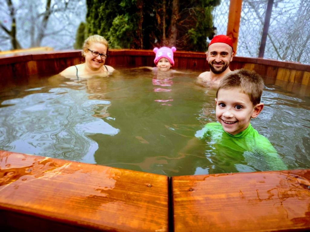 a group of people swimming in a hot tub at Kukucs Etyek Dézsafürdő Vendégház in Etyek