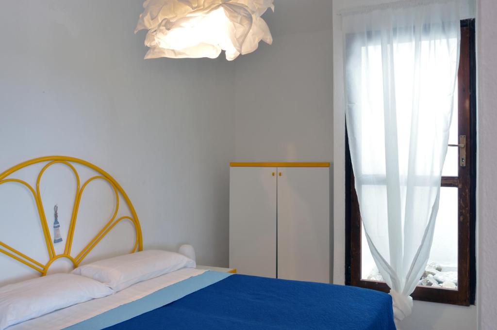 A bed or beds in a room at Terrazze di Chia