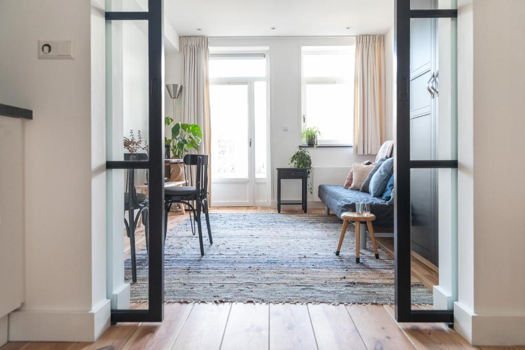 sala de estar con espejo y sofá azul en Gorgeous And Stylish Place For Two In Hip West! en Ámsterdam