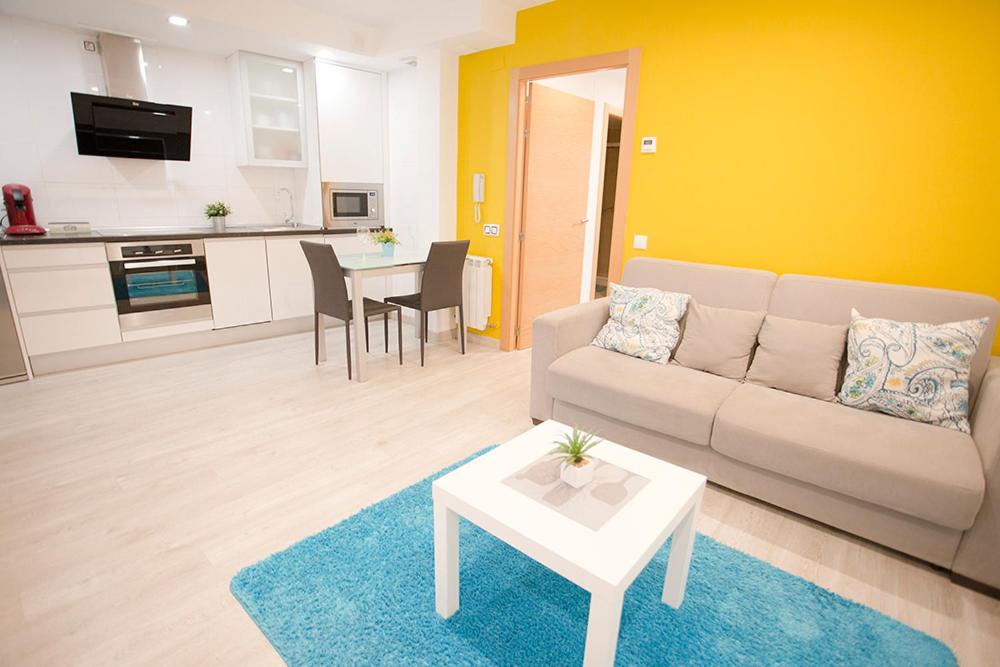a living room with a couch and a table at Apartamentos Amaiur 2 in Estella