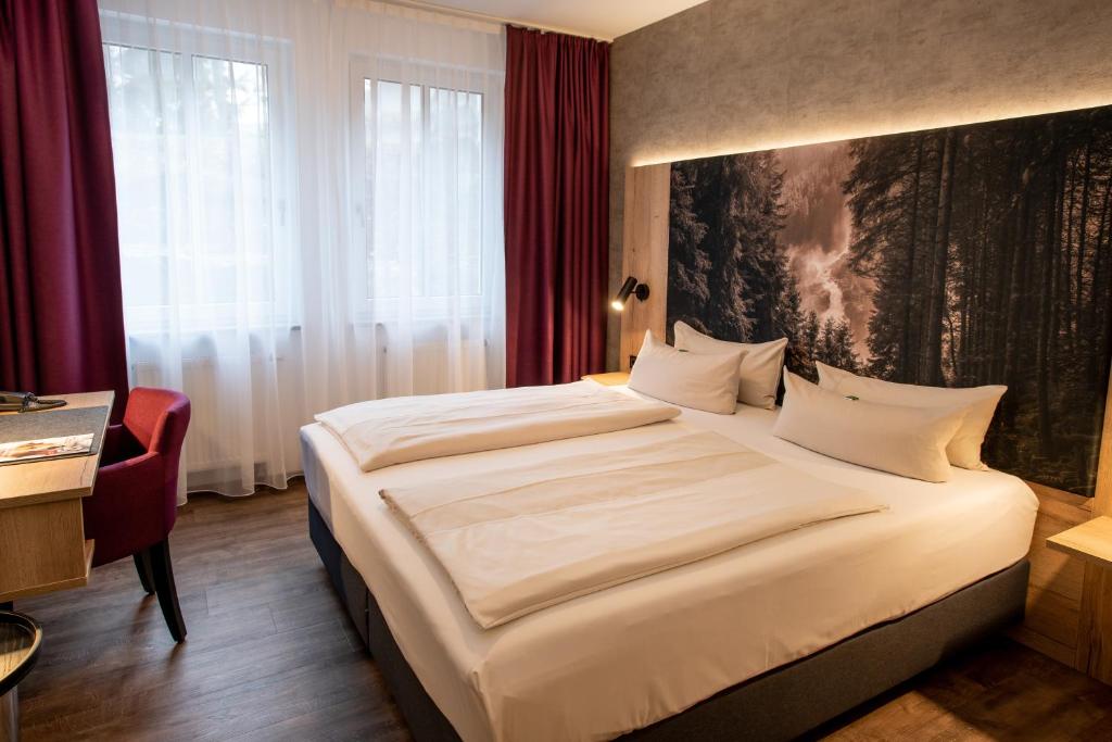 Postel nebo postele na pokoji v ubytování Arcus Hotel München Messe