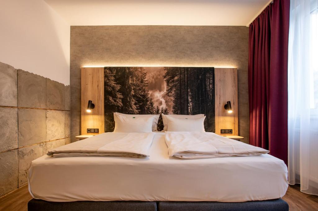 Postel nebo postele na pokoji v ubytování Arcus Hotel München Messe