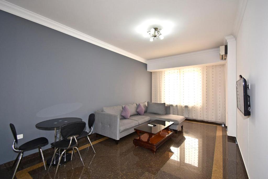 a living room with a couch and a table at Buzand street 1 bedroom Newly Renovated apartment near Republic Square BU777 in Yerevan