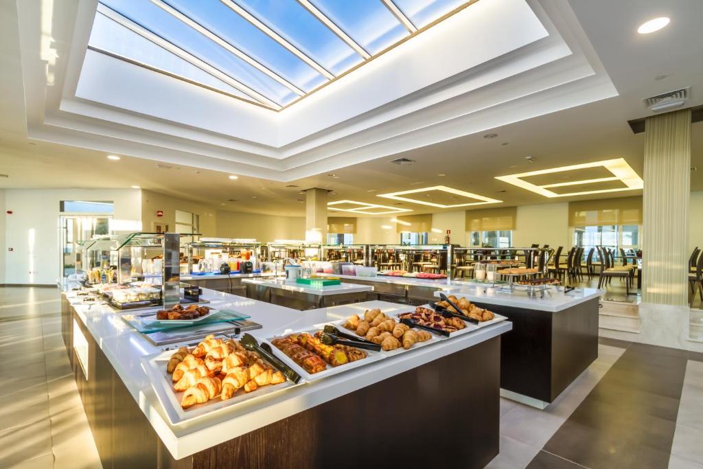 a buffet in a hotel with food on display at Royal Palm Resort & Spa - Adults Only in Playa Jandia