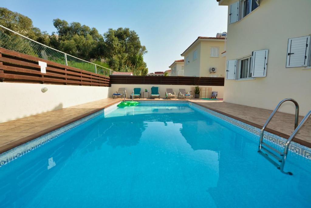 a swimming pool in the backyard of a house at Anasta villa in Protaras