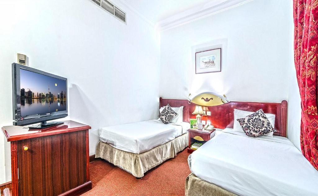 Postel nebo postele na pokoji v ubytování Zain International Hotel