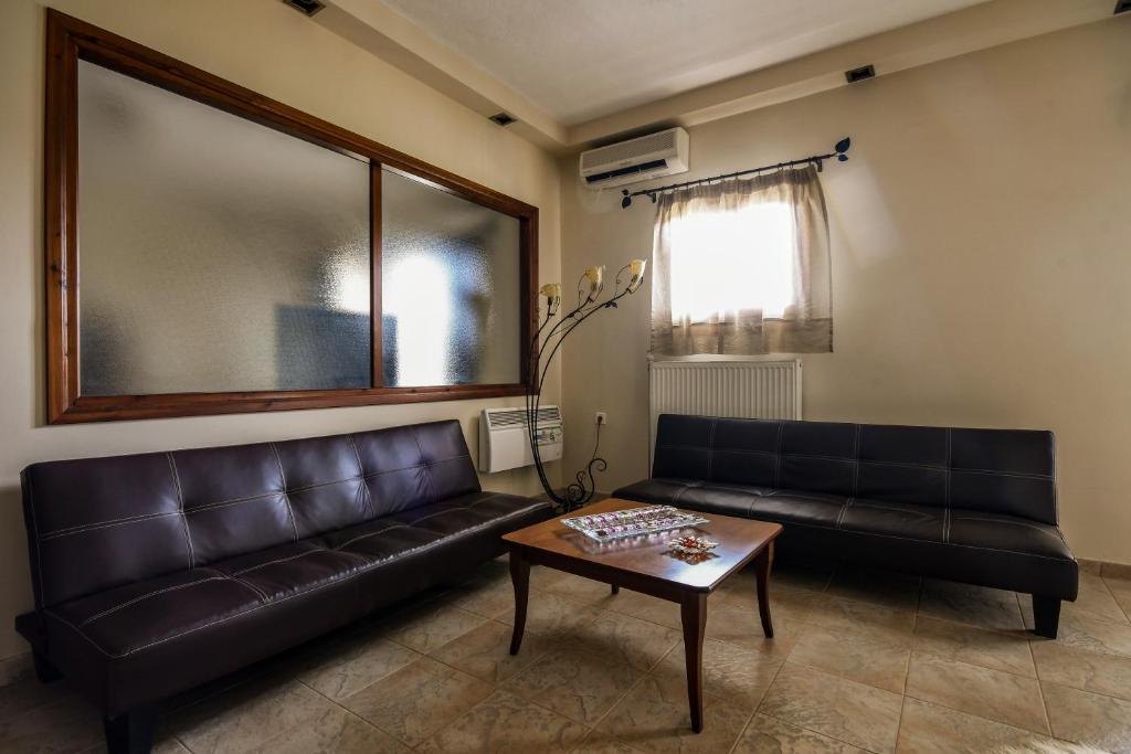a living room with a leather couch and a coffee table at Archontiko Liamas in Stavros