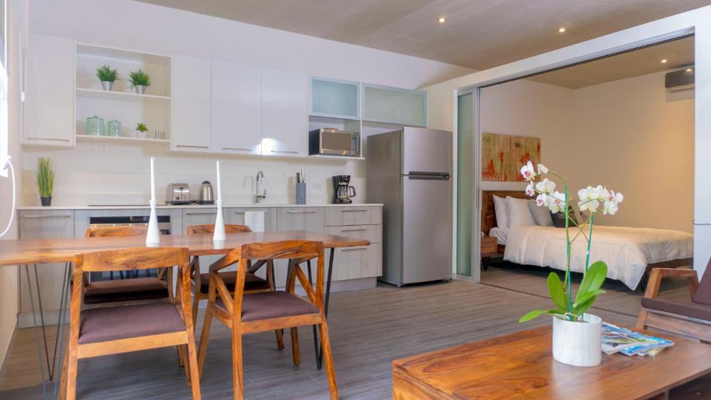 a kitchen and living room with a table and chairs at BEE Suites Santa Ana in Santa Ana