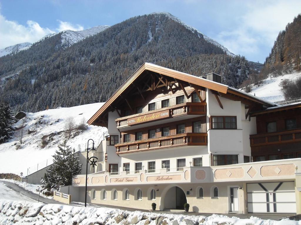 a hotel in the mountains with snow on the ground at Hotel Garni Belvedere in Ischgl
