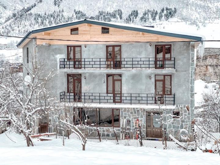 a large house in the snow with snow at Hotel panorama svaneti in Mestia