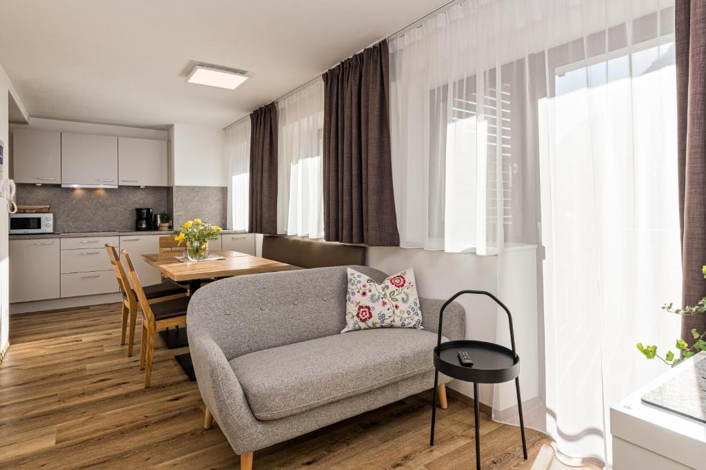 a living room and kitchen with a couch and a table at Appartement Wiere in Molini di Tures