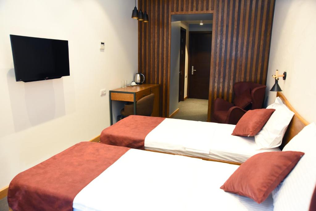 Postel nebo postele na pokoji v ubytování R&R Hotel