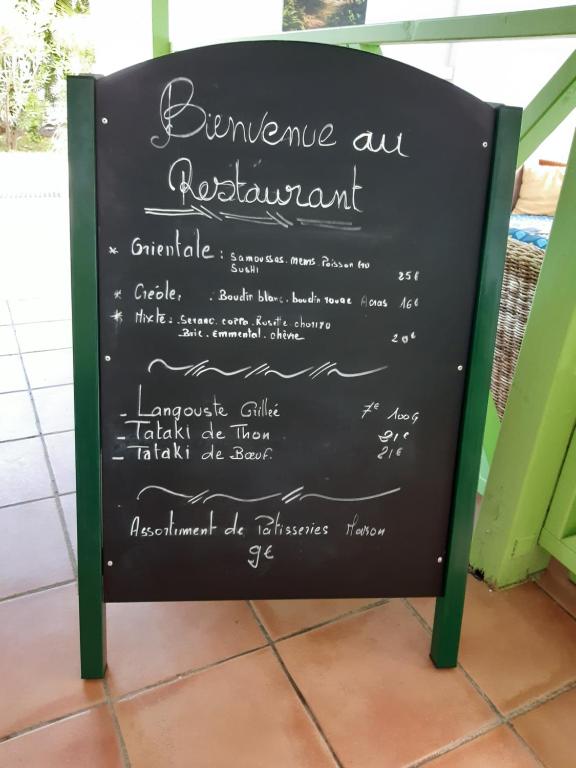 a chalkboard menu sign for a restaurant at La Rose du Bresil Marie-Galante in Capesterre