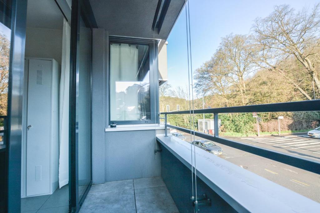 a bathroom with a window and a view of a street at Il Mare appart hotel 1,2,4 in Luxembourg