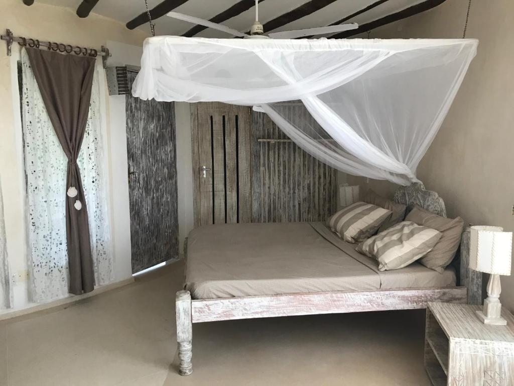 Postel nebo postele na pokoji v ubytování Fortamu Twiga-House