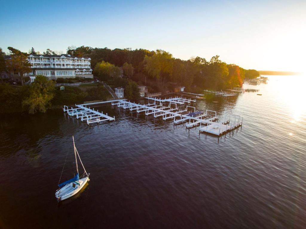 a boat sitting in the water next to a dock at The Geneva Inn in Lake Geneva