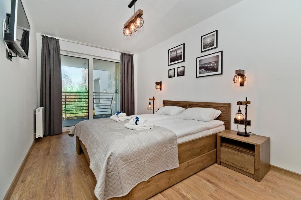 Postel nebo postele na pokoji v ubytování BlueApart Apartamenty Na Klifie