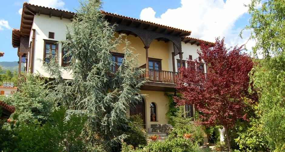 a large house with a balcony on the side of it at Mansion Viglatoras in Ano Poroia