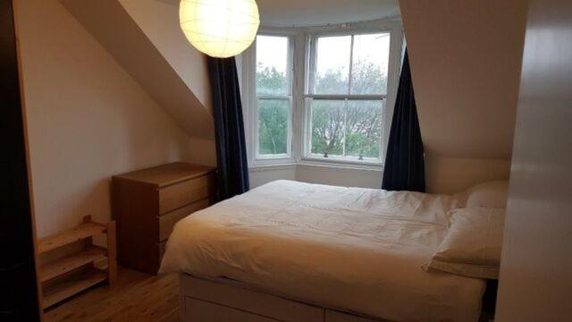 a bedroom with a bed and a window at Beautiful king room in Leith Walk in Edinburgh