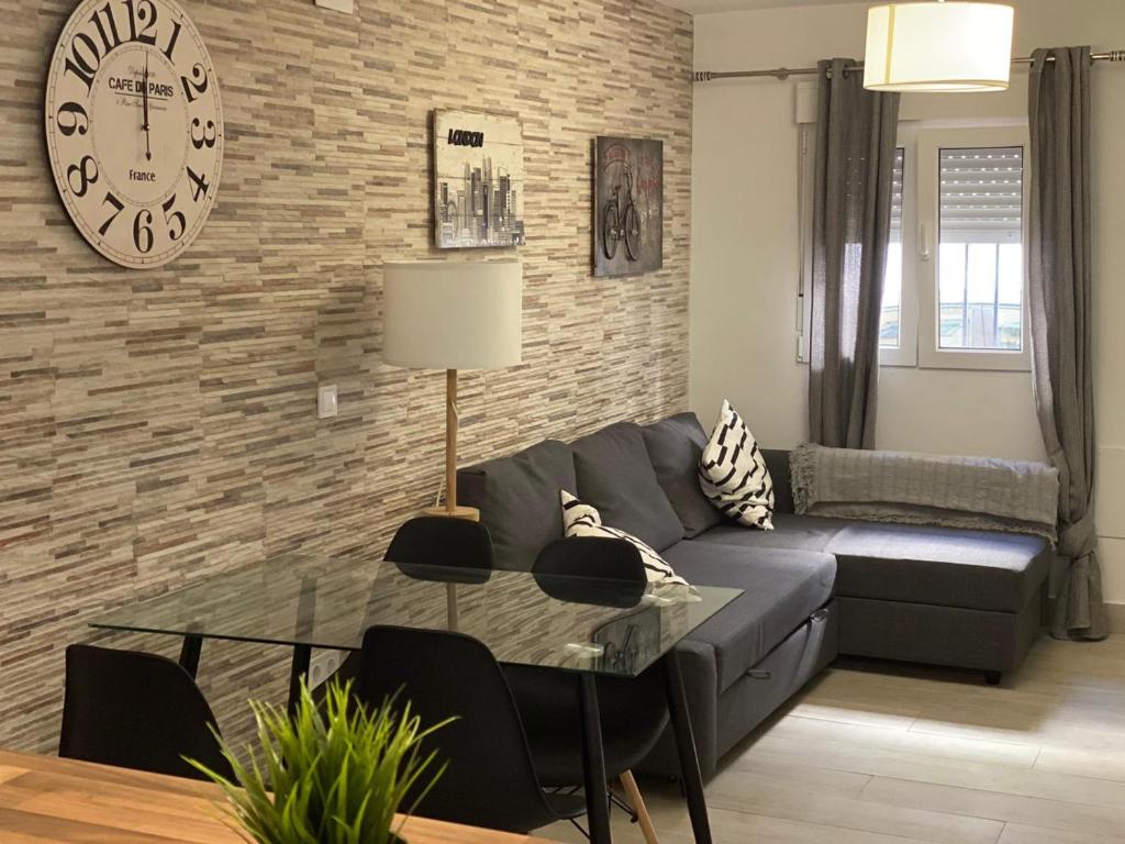 a living room with a couch and a table at WISH SUITE NIEBLA DE SEVILLA in Seville