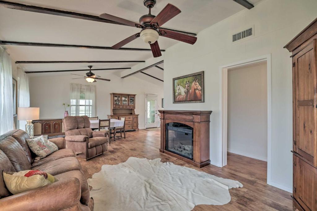 a living room with a ceiling fan and a fireplace at Carmine Cottage with Porch on Beautiful 60-Acre Farm in Carmine