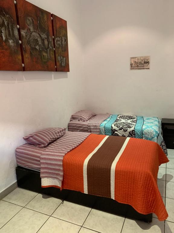 Postel nebo postele na pokoji v ubytování Hotel Cuauhtemoc