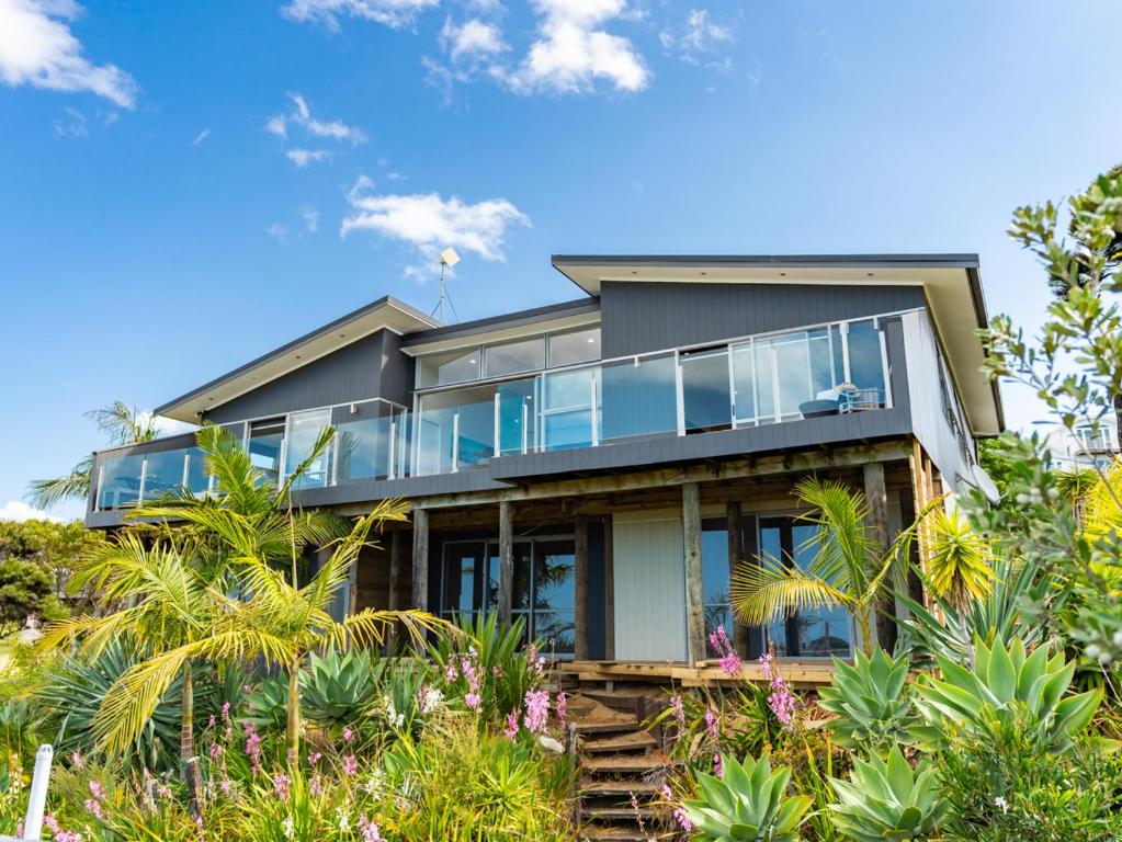 a house on the hill with plants at Cheviot's Hideaway - Mangawhai Heads Holiday Home in Mangawhai