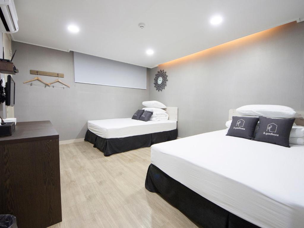 a room with two beds and a chalkboard at K-Grand Hostel Gangnam1 in Seoul