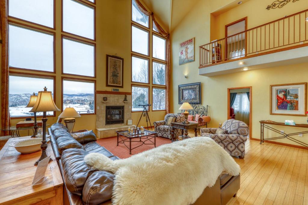 a large living room with a couch and a fireplace at The Timberwolf on Cotton Ranch in Eagle