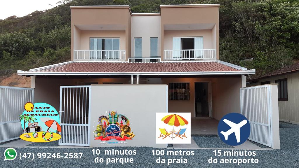 a house with a sign in front of it at Canto da Praia Aconchego in Penha