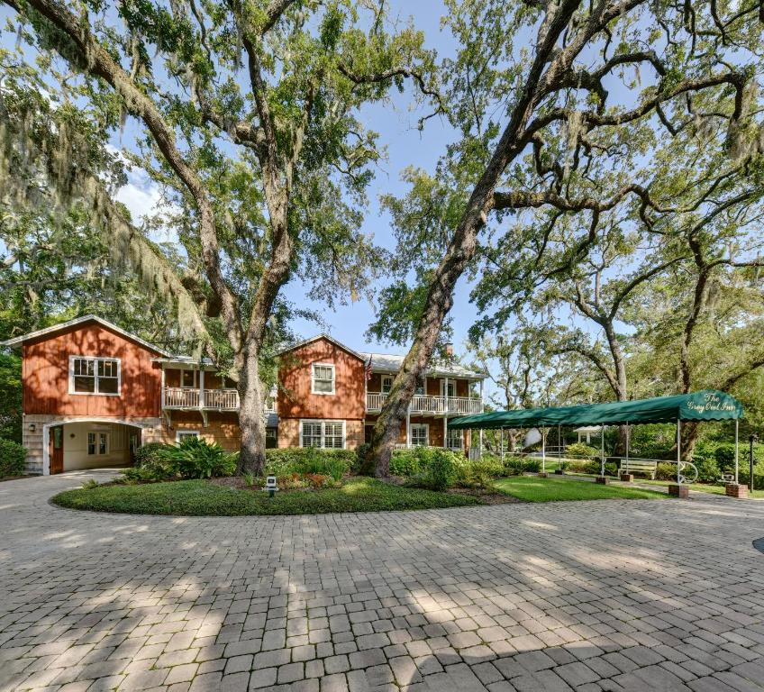 an estate with a large house and trees at The Grey Owl Inn in Saint Simons Island