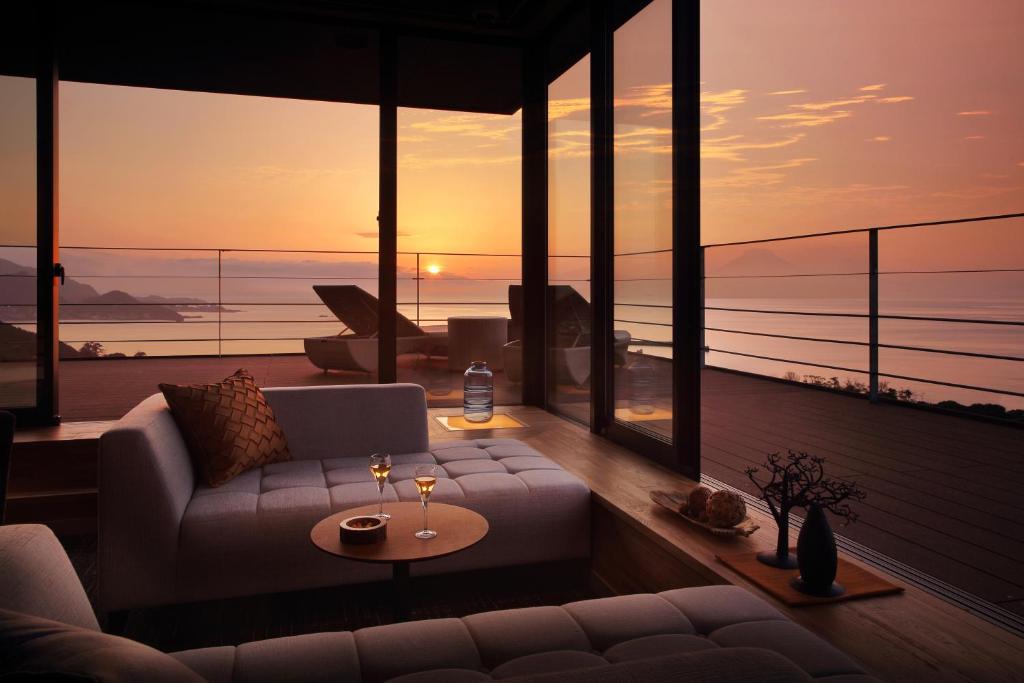 a living room with a couch and a view of the ocean at The Shinra in Tateyama