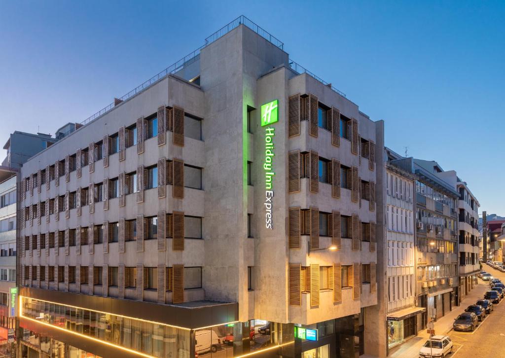 a building with a sign on the side of it at Holiday Inn Express Porto City Centre, an IHG Hotel in Porto