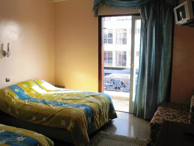 Postel nebo postele na pokoji v ubytování Hotel les palmiers